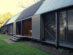 a black and white photo of the outside of a building with wooden slats on it