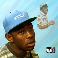 a man wearing a blue hat with the word wolf on it and an image of a police officer behind him