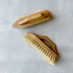 two wooden brushes sitting next to each other