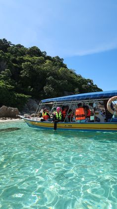 a group of people on a boat in the water