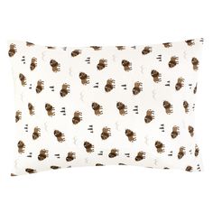 a white and brown pillow with an animal print on the front, sitting on a white surface