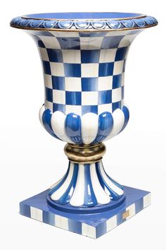 a blue and white vase sitting on top of a table