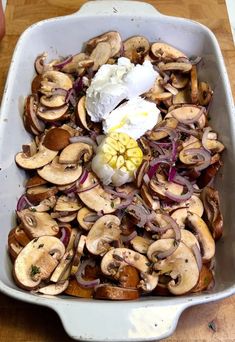 the dish is full of mushrooms, onions and an egg on top with sour cream