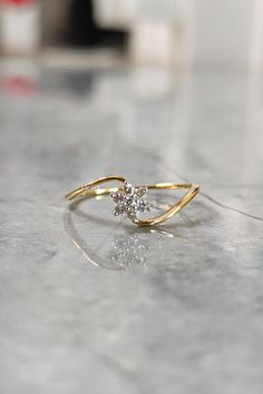 a diamond ring sitting on top of a table