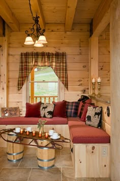 a living room filled with furniture and wooden walls