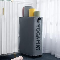 a yoga mat sits on the floor next to a radiator and heater