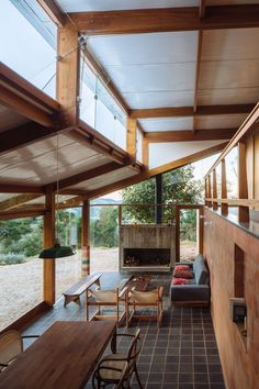 the inside of a house with wood and glass on the walls, windows, and ceiling