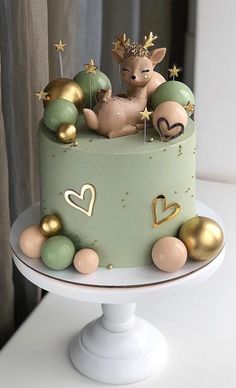 a cake decorated with gold and green decorations