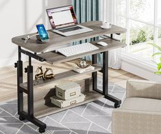 a laptop computer sitting on top of a wooden desk next to a chair in a living room