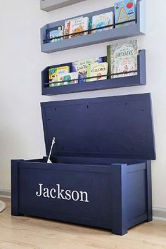 a blue storage box with books on the top and shelves above it that says, jackson