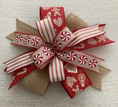 a red and white bow with candy canes on it