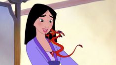 a woman in purple holding a red dragon on her shoulder and looking at the camera