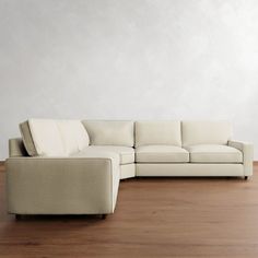 a white couch sitting on top of a hard wood floor next to a wooden floor