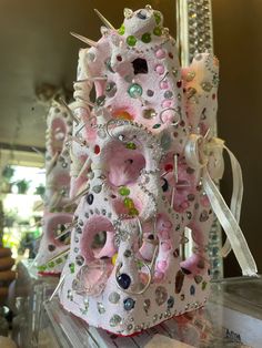 there is a pink and white sculpture made out of buttons