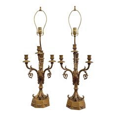 a pair of antique brass candelabras with candlesticks on each side