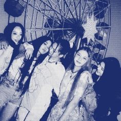 group of young women posing in front of a ferris wheel