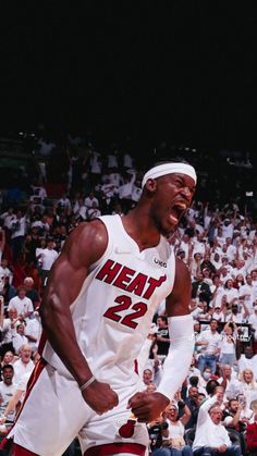 a basketball player with his mouth open in front of an audience