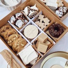 a box filled with lots of different types of cookies and pastries on top of a table