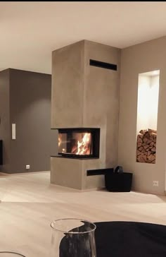 a living room filled with furniture and a fire place next to a wall mounted tv