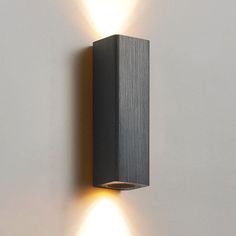 two lights that are on the side of a wall