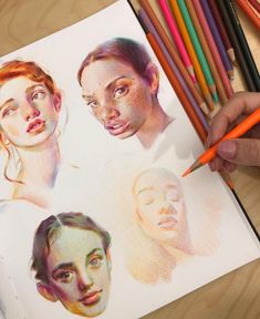 a person is drawing with colored pencils on top of a paper that has pictures of people