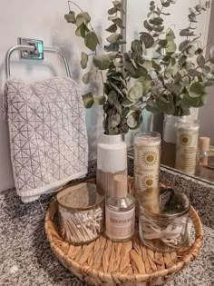 a bathroom sink with soap, lotion and flowers on it