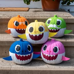 pumpkins decorated to look like shark heads on steps