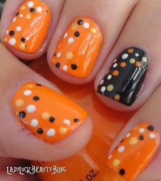 "Halloweeeeen!" - short rounded nails with a black based ring finer with white, orange and orange polka dot detail. rest of nails are orange based with black, white and light orange polka dot detail.