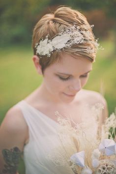 a woman in a white dress holding flowers