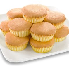 a white plate topped with yellow cupcakes