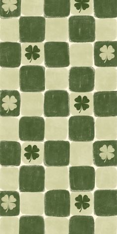 a green and white tile with shamrocks on it