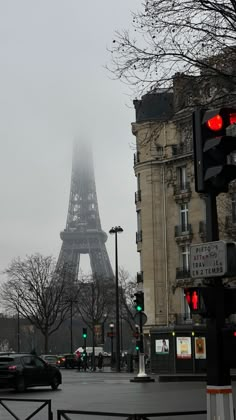 the eiffel tower is in the distance on a foggy, overcast day