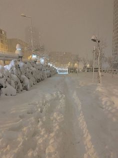 the snow is piled up on the sidewalk