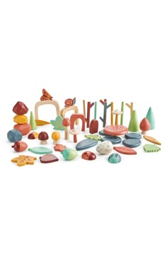 an assortment of wooden toys sitting on top of a white surface