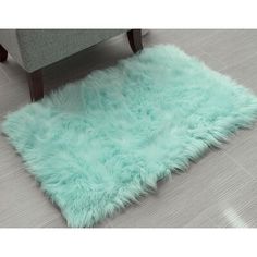 a light green area rug on the floor