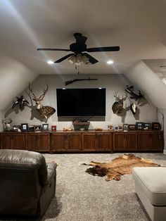 a living room filled with furniture and a flat screen tv mounted to the side of a wall