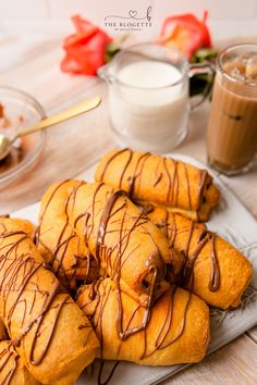 there are many pastries on the plate with chocolate drizzle