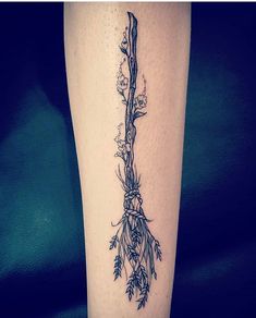 a tattoo on the leg of a woman with flowers and vines growing out of it