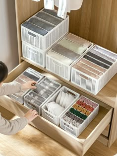 a woman looking at drawers in a closet