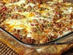 a casserole dish with meat, cheese and vegetables in it sitting on a table