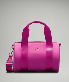 a bright pink handbag on a gray background