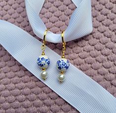 Cute porcelain bead earrings. Made with Small Blue Flower or pink/purple multi colored porcelain flower beads and faux pearls. Hypoallergenic 18k gold plated huggie hoops. Comes in a jewelry box!  ❤️ Handmade in the PNW ❤️ Simple Small Dangle Earrings, Blue White Earrings, Blue And White Porcelain Jewelry, Porcelain Beads Jewelry, Goblin Brain, Blue And White Earrings, China Earrings, Bachelorette Theme, Digital Wardrobe