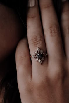 a close up of a person's hand with a ring on their finger,