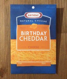 a package of birthday cheddar cheese sitting on top of a wooden table