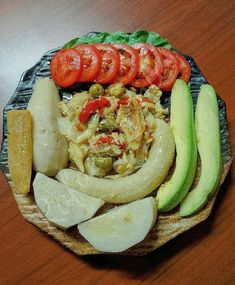 an assortment of vegetables are arranged on a plate with some sliced up tomatoes and cucumbers