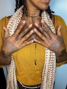 a woman with tattoos on her hands and chest