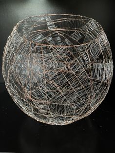 a wire bowl sitting on top of a table