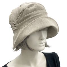 HANDMADE IN THE USAAlice, a stunning cloche in simple sustainable linen; a unique and elegant hat.A wonderful cloche which can be dressed up or worn without an accessory.This hat will take you through many occasions and events, from a summer wedding to a walk along the beach and many others in between. This style gives practicality and beauty.Made with a wide brim which is significantly wider at the front than the back and hence can be styled many ways.This Alice is shown here made with every at Classic Linen Hat With Curved Brim, Cream Linen Hats For Spring, Cream Linen Hat For Spring, Cream Linen Spring Hat, Beige Linen Hat With Short Brim, Chic Beige Cloche Hat With Short Brim, Natural Linen Sun Hat For Spring, Natural Linen Hats For Spring, Fitted Beige Cloche Hat