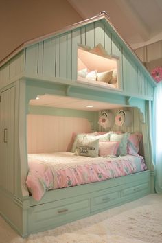 a child's bedroom with a bunk bed made out of wood and pink pillows