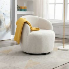 a white chair with a yellow blanket on it